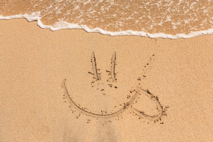 Sun Written in the Sand on a Beach